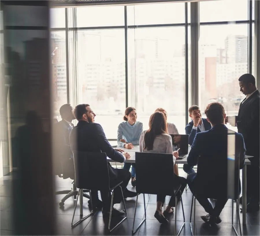 A young team sits in a meeting in a modern office.