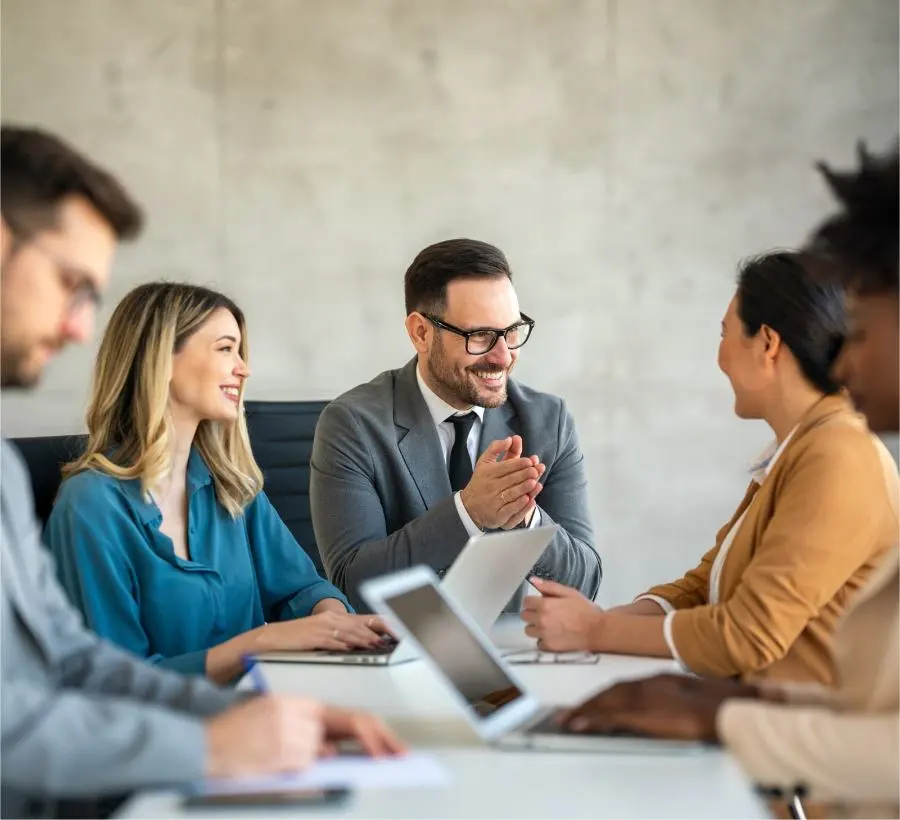 A man expresses his pleasure and appreciation to his team in a meeting.