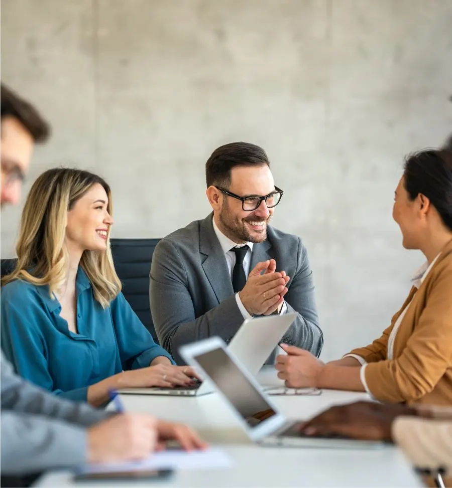 A man expresses his pleasure and appreciation to his team in a meeting.