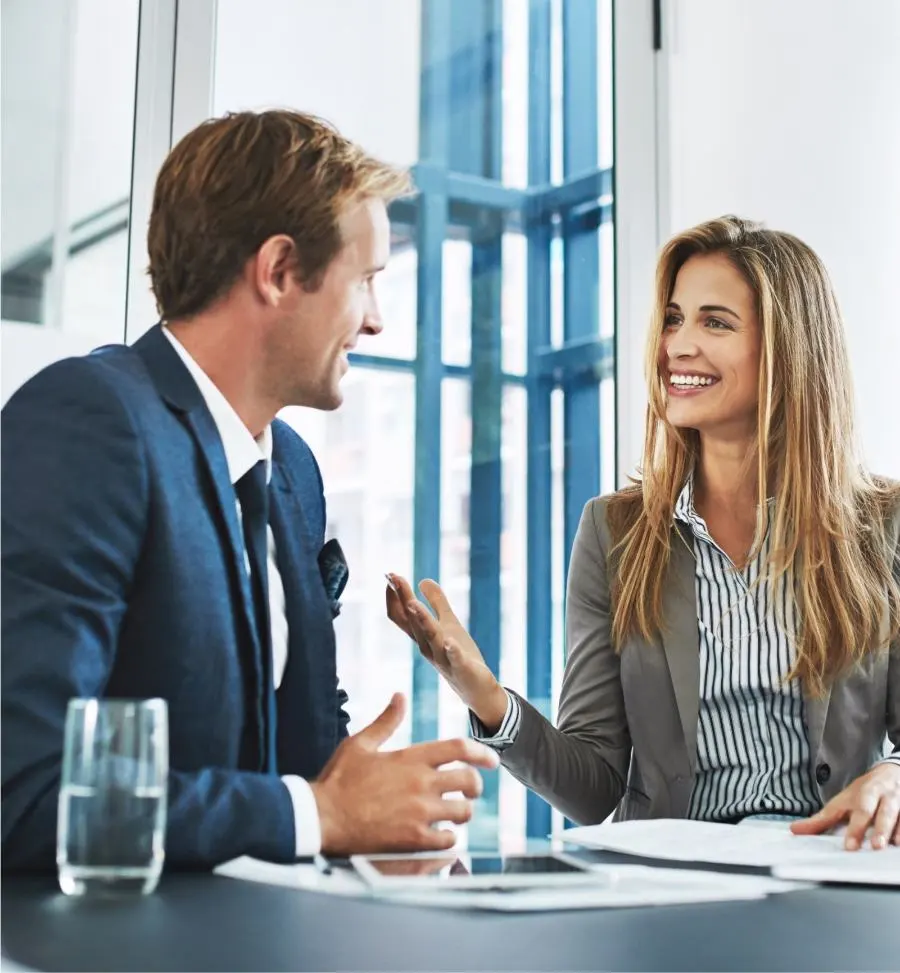 A woman and a man in a suit talk to each other with interest.