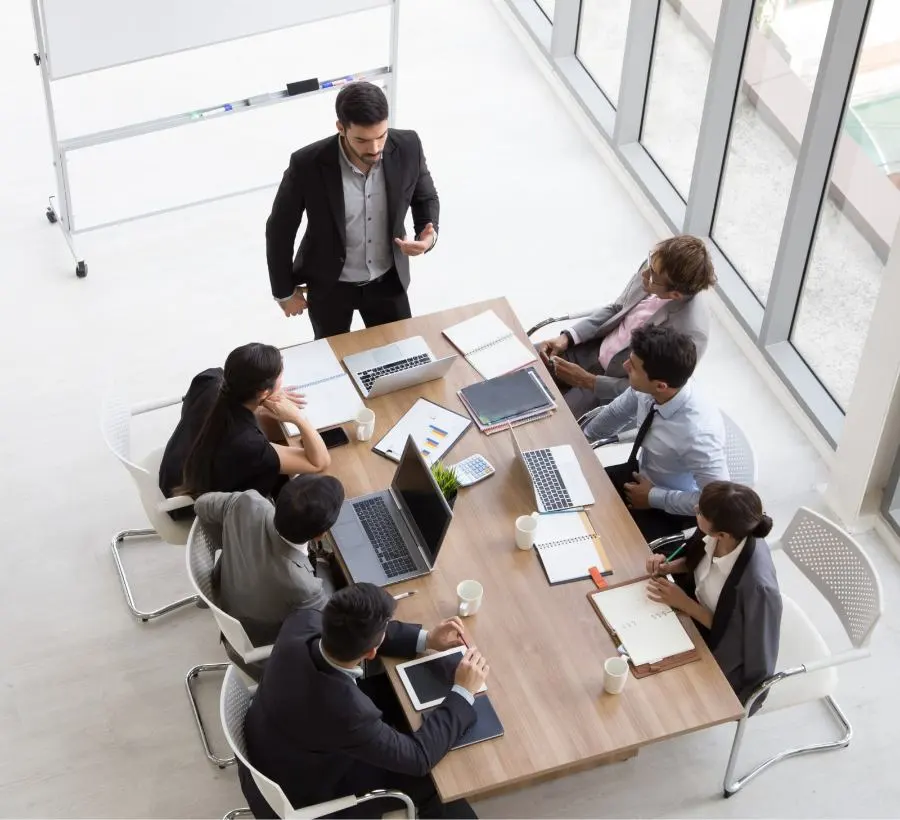 A bird's eye view of a meeting with seven people.